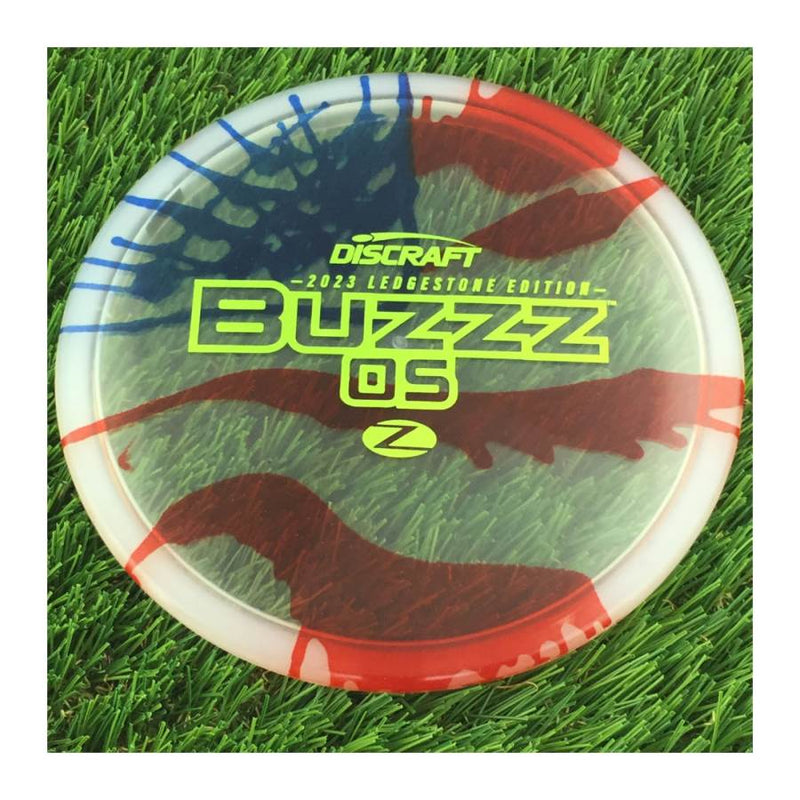 Discraft Elite Z Fly-Dyed BuzzzOS with 2023 Ledgestone Edition - Wave 2 Stamp - 180g - Translucent Flag