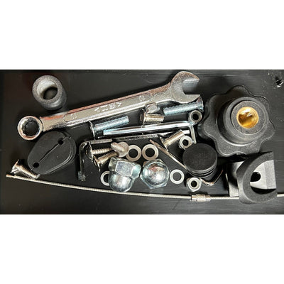 Assorted zuca cart tune-up kit components including a silver wrench, various screws, nuts, washers, and black plastic parts.