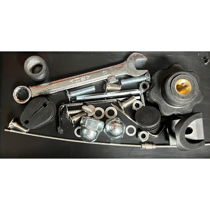 Assorted zuca cart tune-up kit components including a silver wrench, various screws, nuts, washers, and black plastic parts.