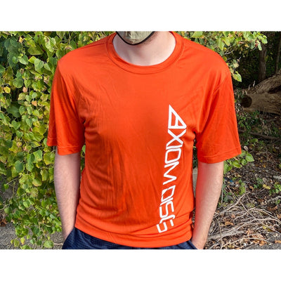 Model wearing an orange Axiom Disc sidebar performance tee with a white vertical logo on the side.