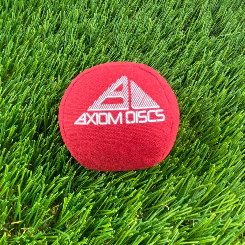 Red Axiom Osmosis Sport Ball Bag with a bright white embroidered Axiom Discs logo on the front surface.