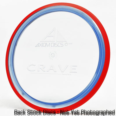 Translucent Axiom Proton Crave Fairway Driver disc golf disc with a red rim and a blue inner ring.