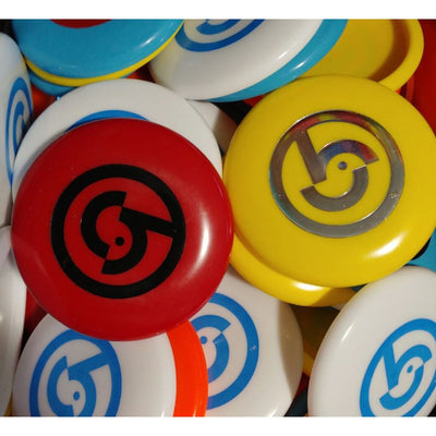 A pile of round plastic Birdie mini markers in red, yellow, white, and blue with a stylized bird logo.