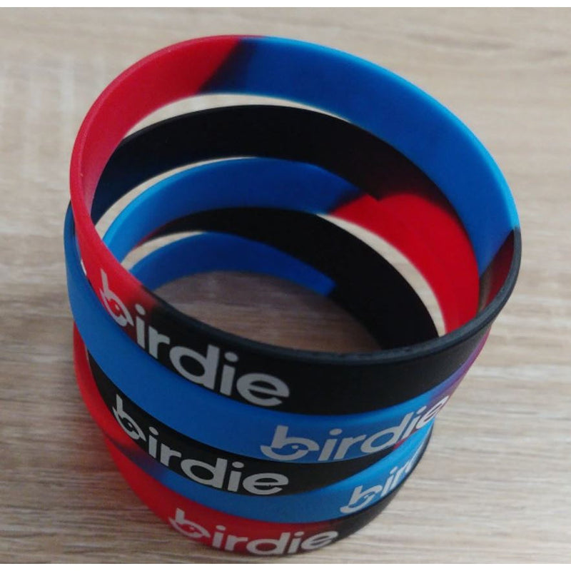 Assortment of red, blue, and black silicone wristbands prominently featuring the white "birdie" logo in stacked piles.
