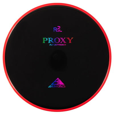 Black axiom r2 neutron proxy disc golf putt approach disc with a vibrant red rim and colorful lettering.