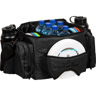 Black dynamic discs soldier cooler bag filled with water bottles and discs, with two black water bottles in side pockets.