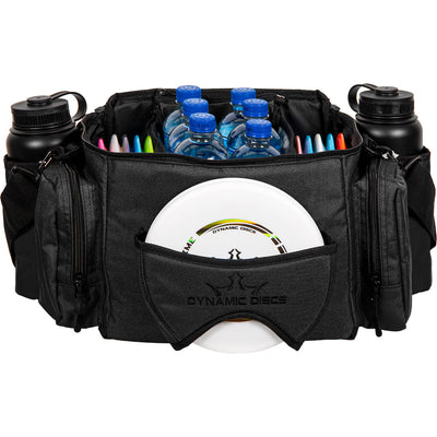 Black dynamic discs soldier cooler disc golf bag filled with water bottles and colorful discs, two black water bottles in.