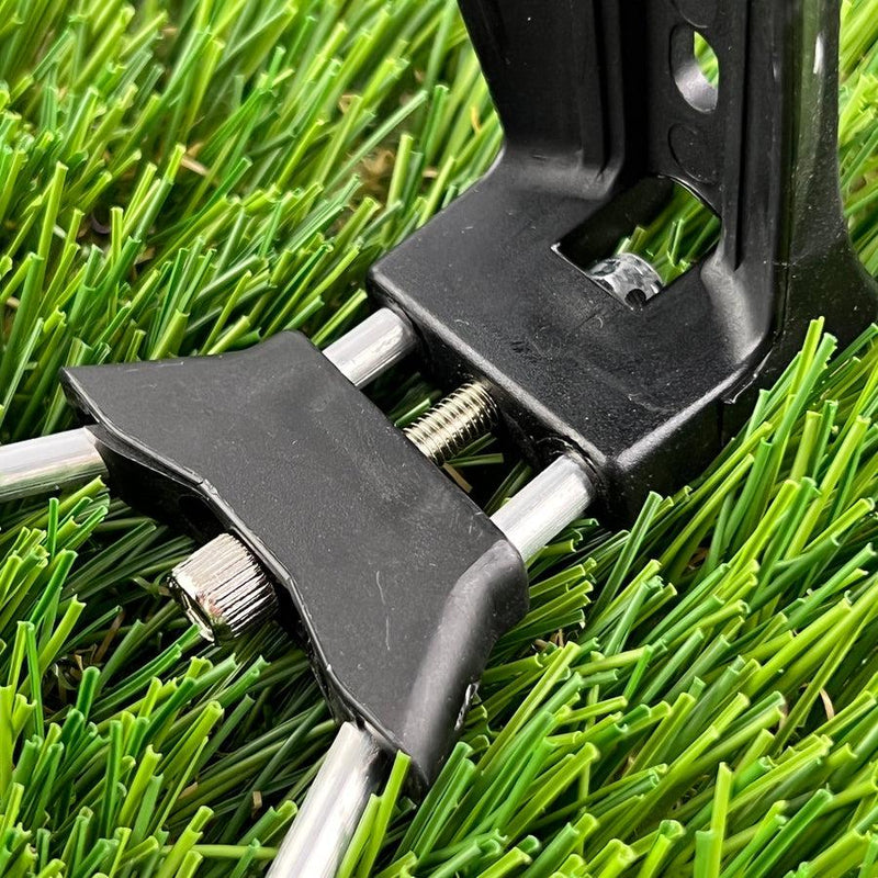 Black plastic zuca cart water bottle holder xl attachment, with silver metal rods and screws, on artificial turf.