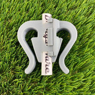 Light gray Briggisware Zuca Cart double putter holder shown holding two white Discmania putters.