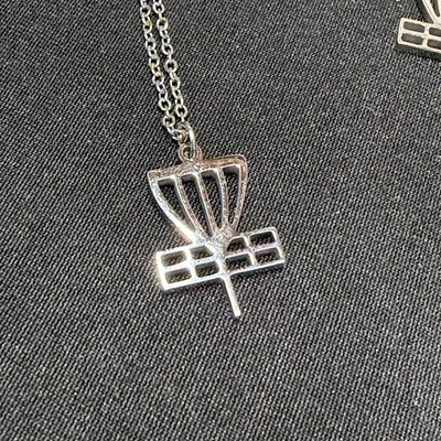 Shiny silver disc golf basket pendant on a delicate chain, displaying a detailed cut-out design.