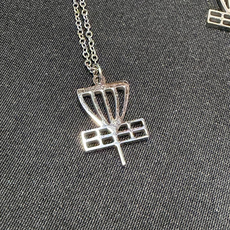 Shiny silver disc golf basket pendant on a delicate chain, displaying a detailed cut-out design.