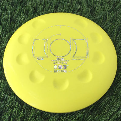 Solid yellow Ching Strato Juju disc golf putter with holographic foil stamp and textured dimples.
