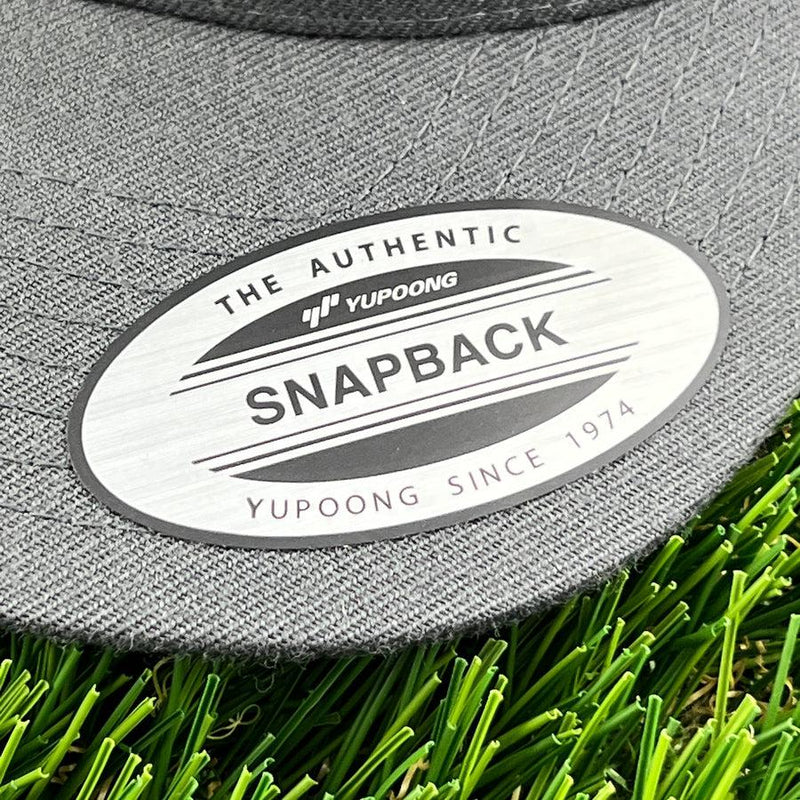 A close-up of a gray yupoong snapback clothback hat&