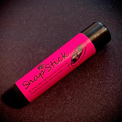 Pink DG Max Wax Snap Stick disc golf grip wax with a black twist-up base and cap.