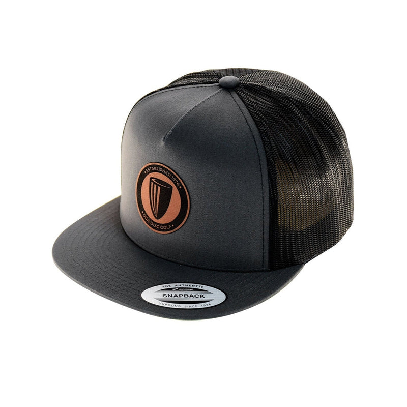 Charcoal flatbill snapback hat featuring a black mesh backing and a brown circular DGA leather patch.