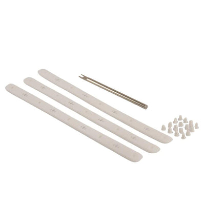 Three white Diadem Icon V2 bumper replacements, a metal installation tool, and a pile of small white plugs.