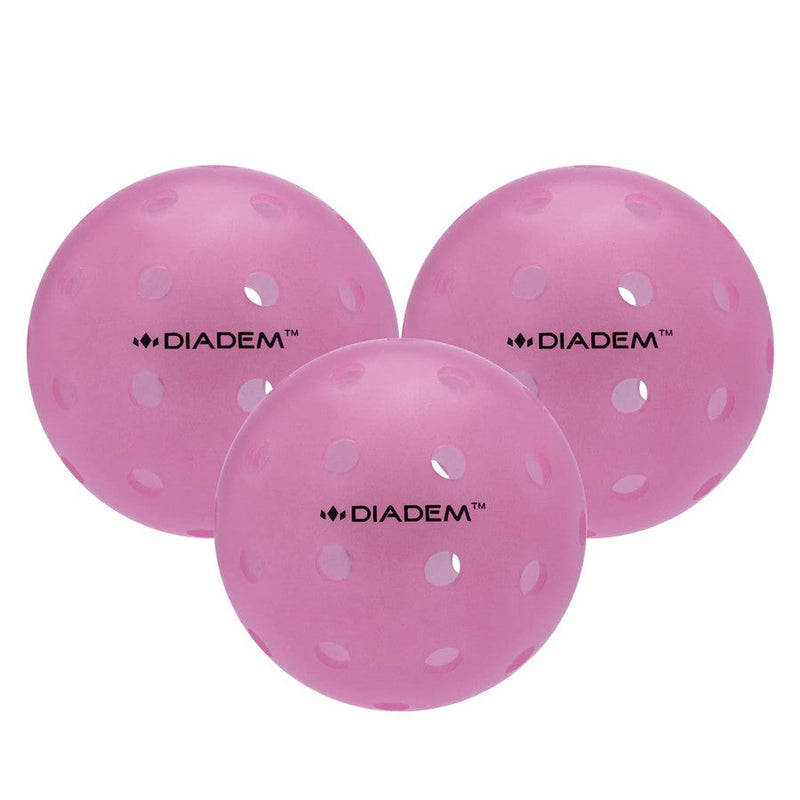 Three bright pink Diadem Power Pickleballs, each featuring multiple circular holes and the company logo in black text.