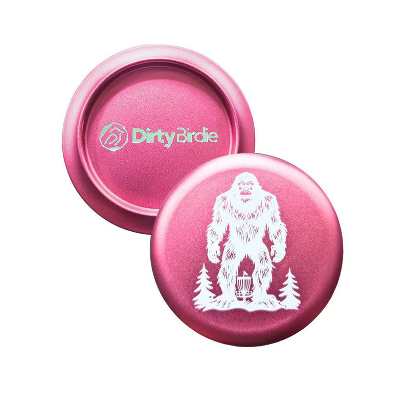 Pink Dirty Birdie aluminum metal marker with an embossed white Sasquatch and pine tree design.