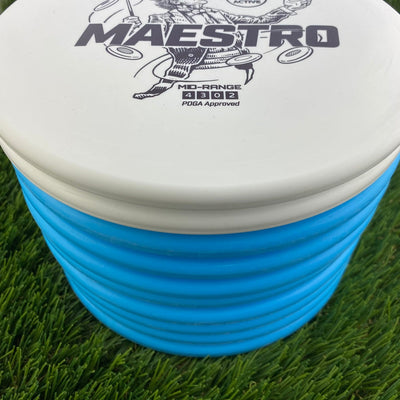 White Discmania Active Base Level Maestro disc golf mid-range disc with a blue bucket base and black graphics.