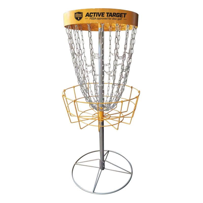 Yellow Discmania Active Target disc golf basket with silver chains and a sturdy metal pole.