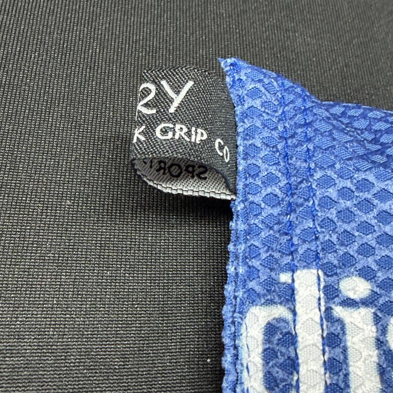 Blue Discmania Sportsack grip bag with an absorbent waffle weave texture and a black fabric tag.