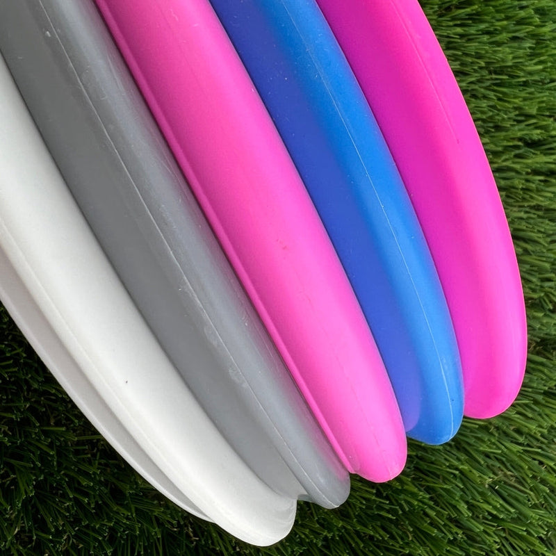 Five Discmania Evolution Exo putter midrange discs in white, grey, magenta, royal blue, and light blue.