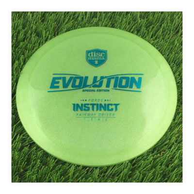 Translucent green Discmania Evolution Instinct special edition Forge stamp disc golf fairway driver with bright blue text.