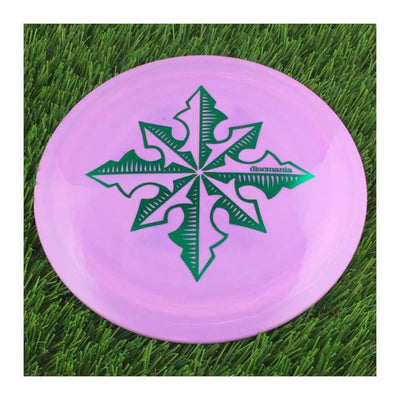 Solid purple Discmania Evolution Lux Instinct disc with a green North Star special edition stamp on top.