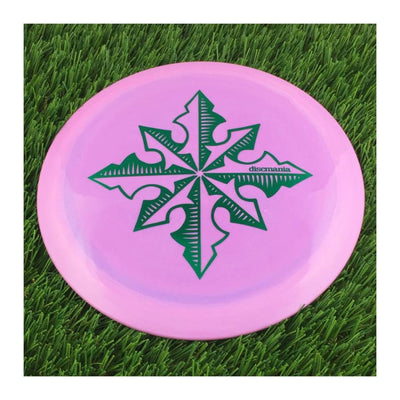 Solid purple Discmania Evolution Lux Instinct disc golf disc with a green "North Star" special edition stamp.