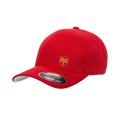 Red Flexfit Discmania hat with an embroidered gold and purple Discmania Wings logo emblem.