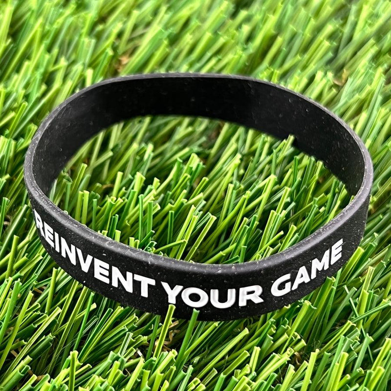 Black Discmania Reinvent Your Game wristband with white text in a bold, sans-serif font.