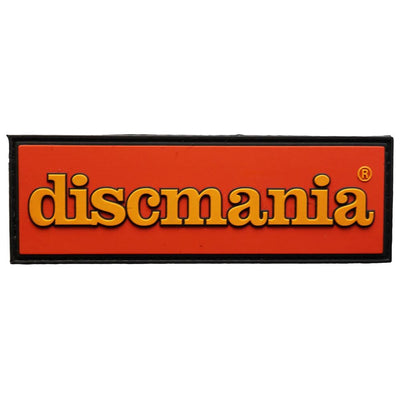 Rectangular orange Discmania rubber patch with raised bold yellow lettering and a black border outlining the design.