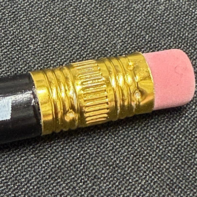 Discraft black score keeping pencil featuring a shiny gold ferrule and a pink eraser.
