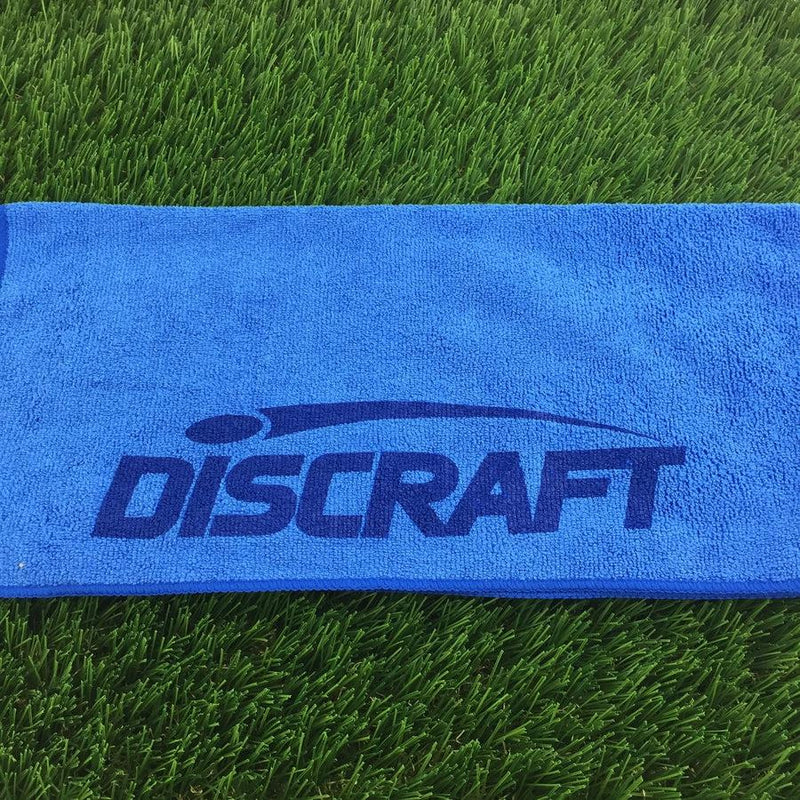 Vibrant blue microfiber golf towel featuring a darker blue printed Discraft logo and a smooth texture.