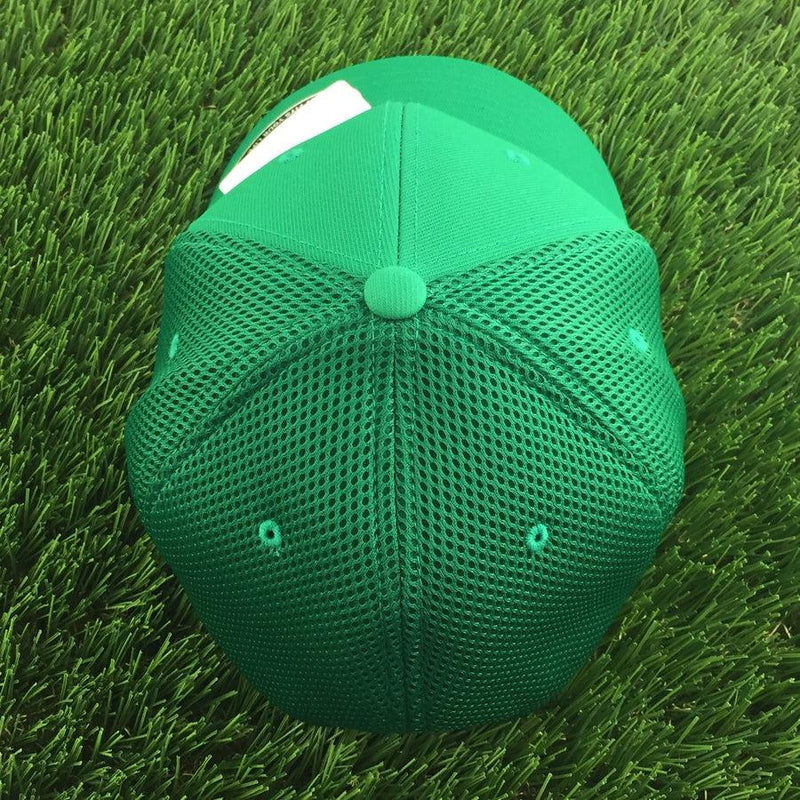 Green Discraft Buzz cap with a full mesh back, circular button, and a flexfit curved bill.