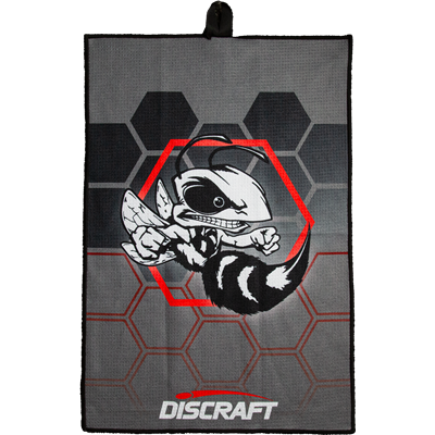 Gray Discraft Buzzz microfiber disc golf towel with a black and white hornet graphic and red hexagonal accents.