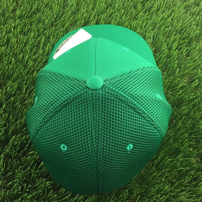Green mesh back Flexfit curved bill hat with a solid green front panel and small vent holes.