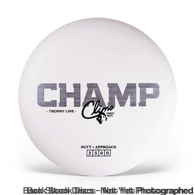 A white Discraft disc golf putter with a large gray "CHAMP" stamp and "Climo first run" in black script.