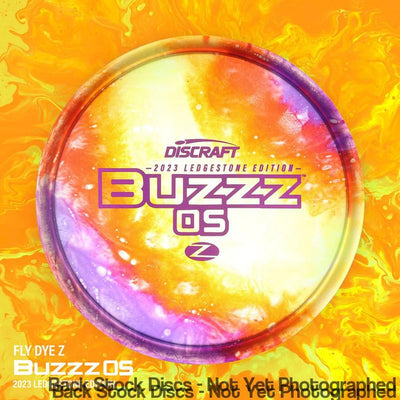 Discraft Elite Z Buzzos 2023 Ledgestone Edition Wave 2 disc with a vibrant yellow, orange, and purple swirl pattern.