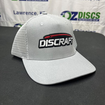 Gray curved bill mesh snap hat with a black, red, and white Discraft embroidered logo on the front panel.