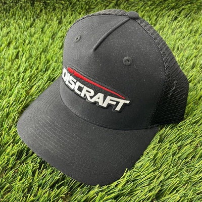 Black Discraft embroidered logo mesh snapback curved bill hat with a white and red stitched logo.