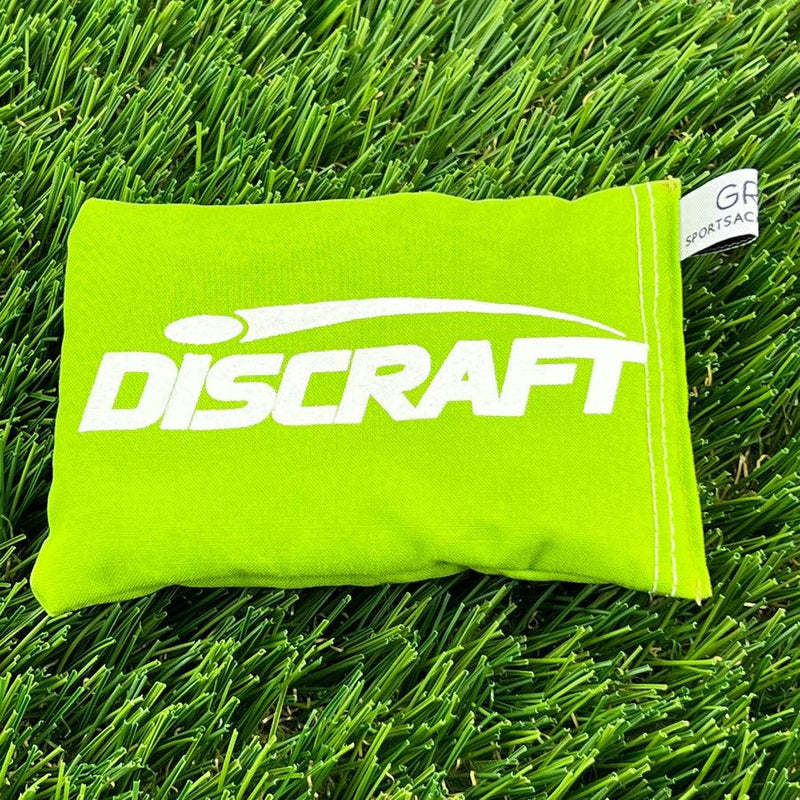Lime green Discraft Sportsack with white brand lettering and a small fabric tag on the side.