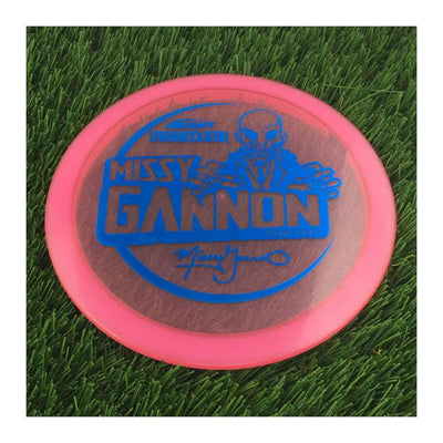 Translucent pink Discraft Metallic Z Undertaker disc golf driver featuring a blue Missy Gannon Tour Series 2021 stamp.