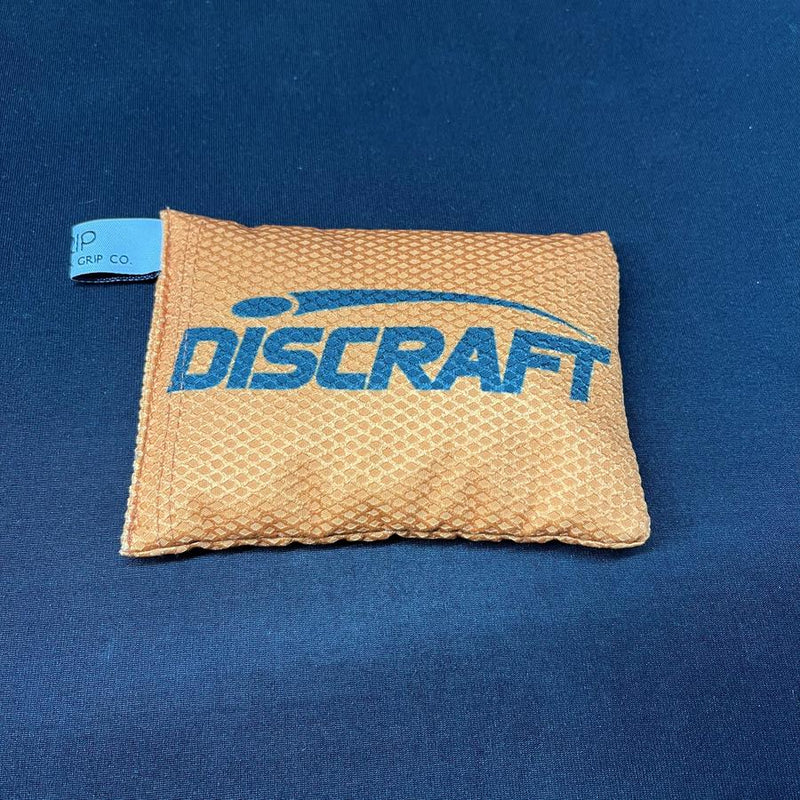Orange Discraft Silky Feel waffle sportsack with a blue Discraft logo and light blue tag.