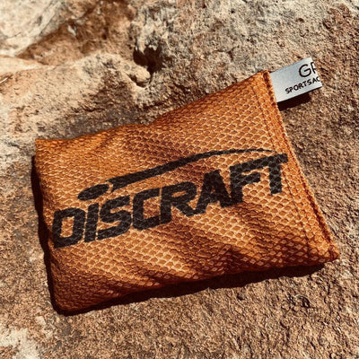 Orange Discraft Waffle Sportsack with black printing and a small white tag in the upper right.