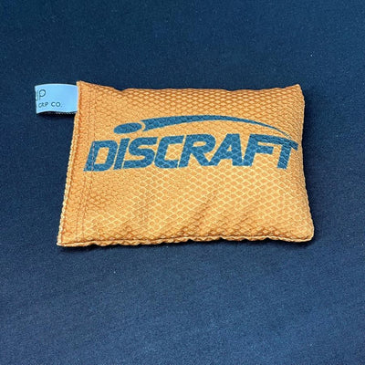 Small orange Discraft Silky Feel Waffle Sportsack with a blue logo and waffle texture.