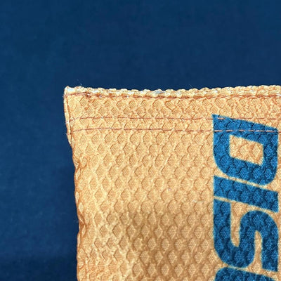 Orange Discraft Silky Feel Waffle Sportsack with a textured grid pattern and blue embroidered "Disc" lettering.