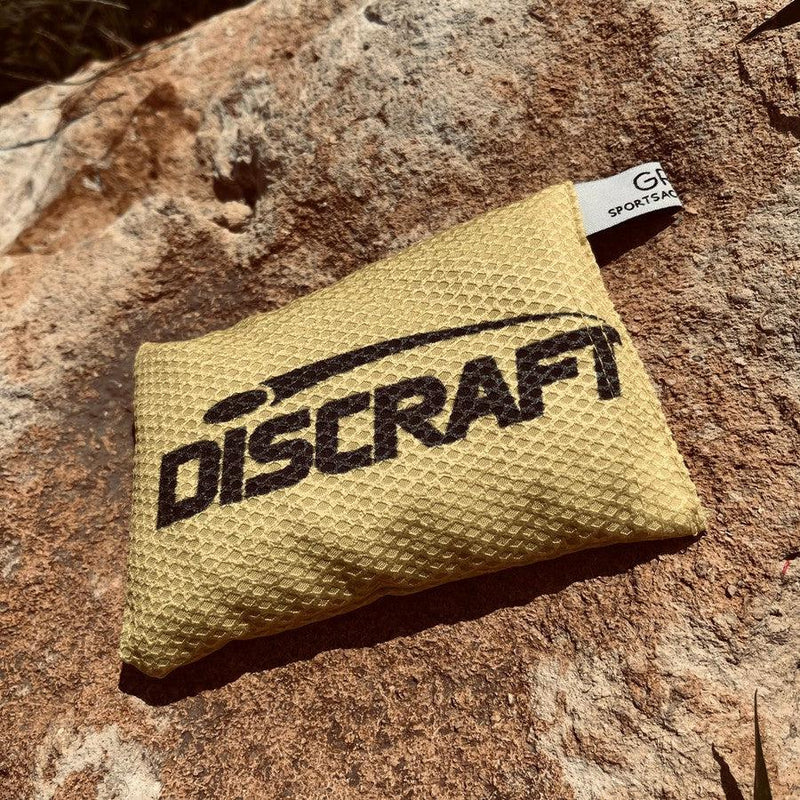 Yellow Discraft Silky Feel Waffle Sportsack with a black Discraft logo, featuring a small white tag on the corner.