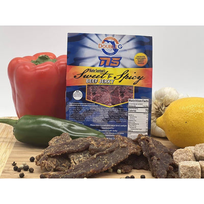 A blue DoubleG Nate Sexton Sweet & Spicy Craft Beef Jerky bag shows ingredients, nutrition facts, and jerky pieces.