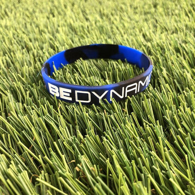 Blue and black camouflage Dynamic Discs Be Dynamic silicone wristband with white lettering.
